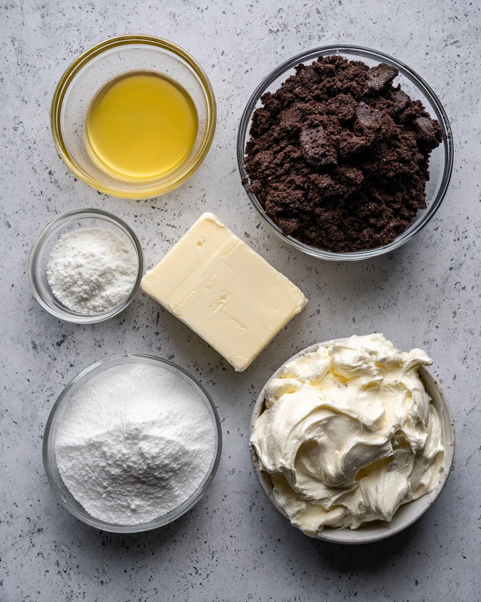 Overhead view of ingredients for grasshopper pie, including chocolate crumbs, butter, sugar, and cream cheese.