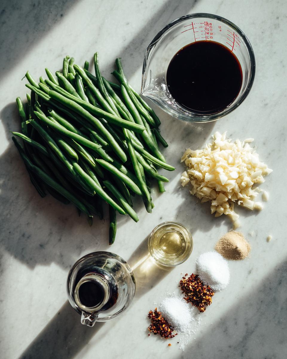 Mise en place ingredients for chinese green beans with garlic sauce, including fresh green beans, minced garlic, soy sauce, and spices.