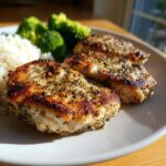 Three seasoned and seared chicken breasts served with rice and broccoli, showcasing the amazing chicken marinade.
